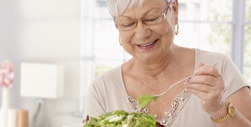 Older woman eating salad