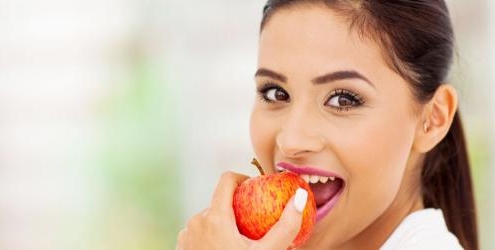 Woman eating apple